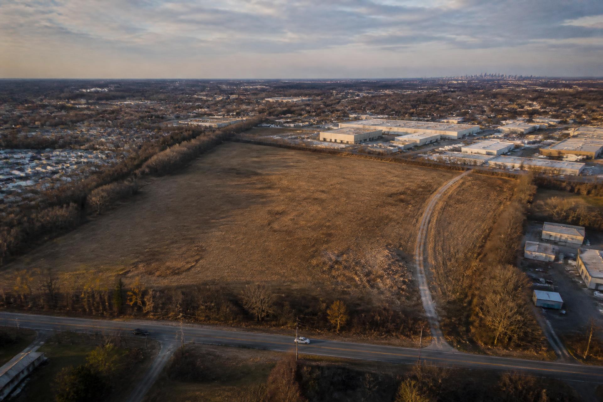 Aerial view of an undeveloped parcel of land adjacent to existing development outside Philadelphia